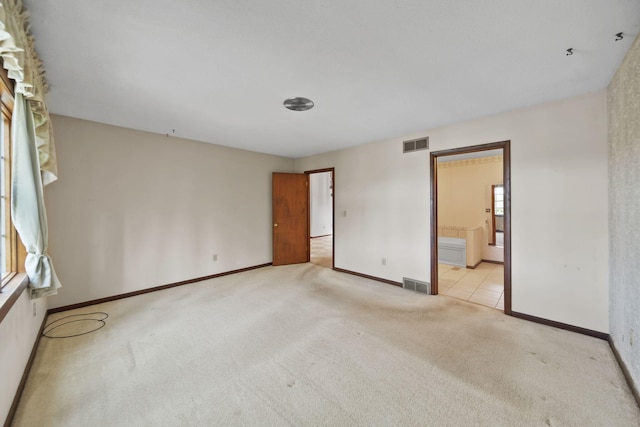 216 Wickenham Dr, Spring Arbor, MI 49283 - unfurnished bedroom with light colored carpet, baseboards, and ensuite bath