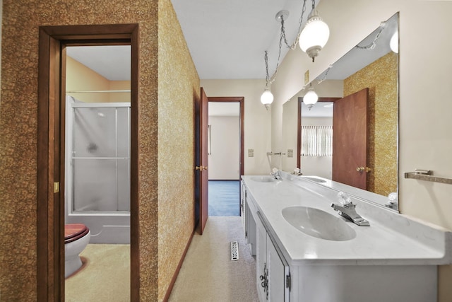 216 Wickenham Dr, Spring Arbor, MI 49283 - bathroom featuring double vanity, toilet, and enclosed tub / shower combo