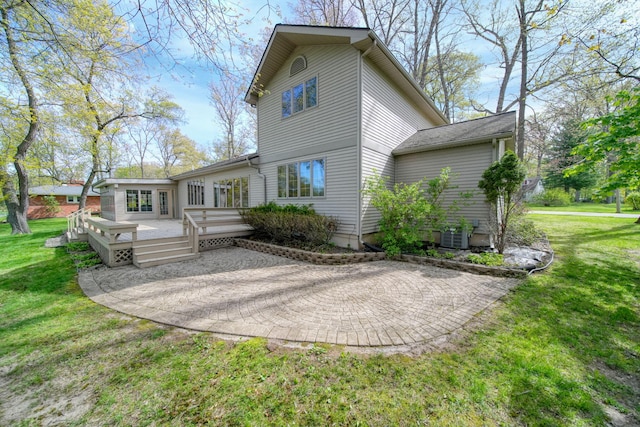 216 Wickenham Dr, Spring Arbor, MI 49283 - back of property featuring a patio area, a lawn, and a wooden deck