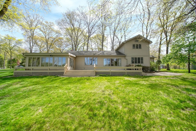216 Wickenham Dr, Spring Arbor, MI 49283 - rear view of house with a sunroom, a wooden deck, and a yard