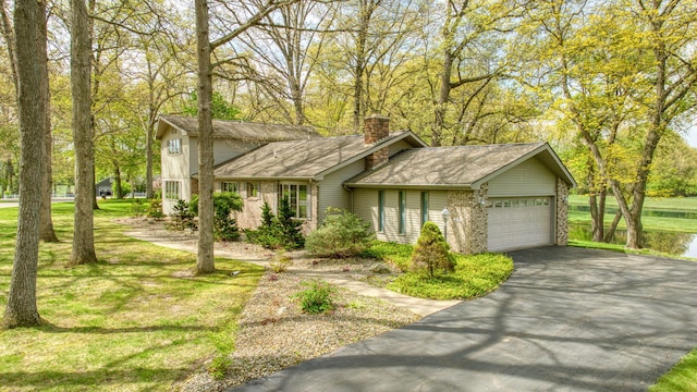 216 Wickenham Dr, Spring Arbor, MI 49283 - traditional home with driveway, an attached garage, a chimney, brick siding, and roof with shingles