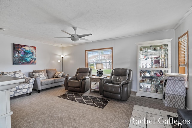 living area with ceiling fan, crown molding, carpet floors, and a textured ceiling