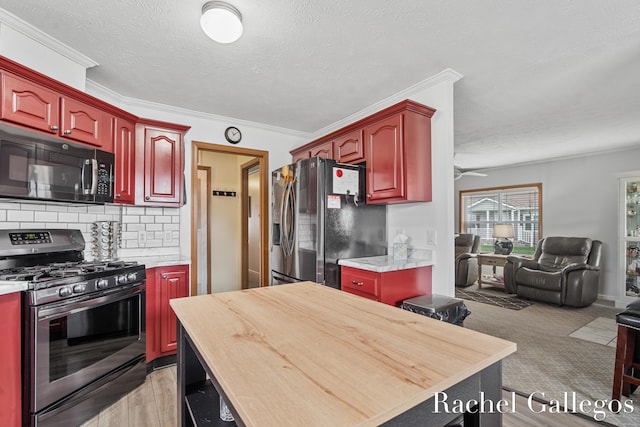 kitchen featuring stainless steel appliances, reddish brown cabinets, open floor plan, tasteful backsplash, and ornamental molding