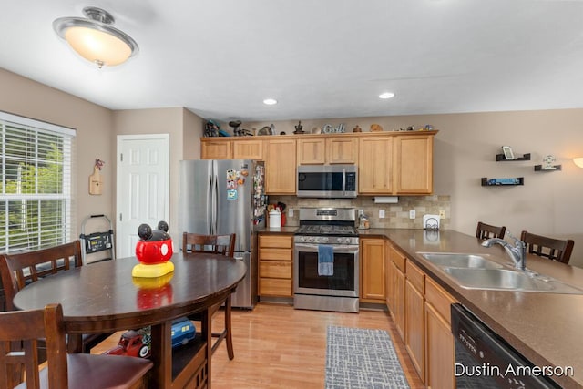 8485 E Center Park Dr SW Unit 18, Byron Center, MI 49315 - kitchen featuring stainless steel appliances, a sink, light wood finished floors, decorative backsplash, and light brown cabinetry