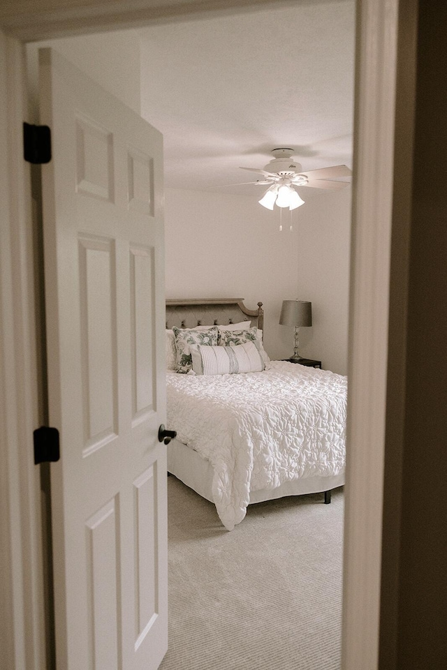 carpeted bedroom featuring a ceiling fan