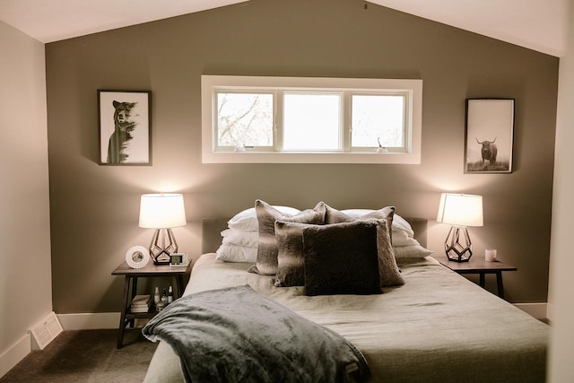 carpeted bedroom featuring vaulted ceiling and baseboards