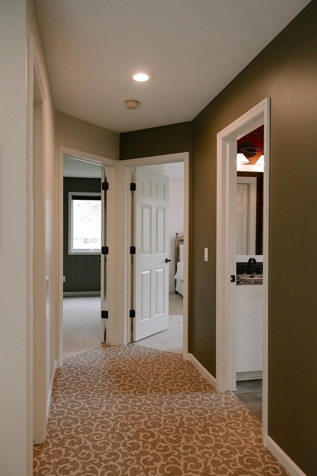 hall featuring carpet, recessed lighting, and baseboards