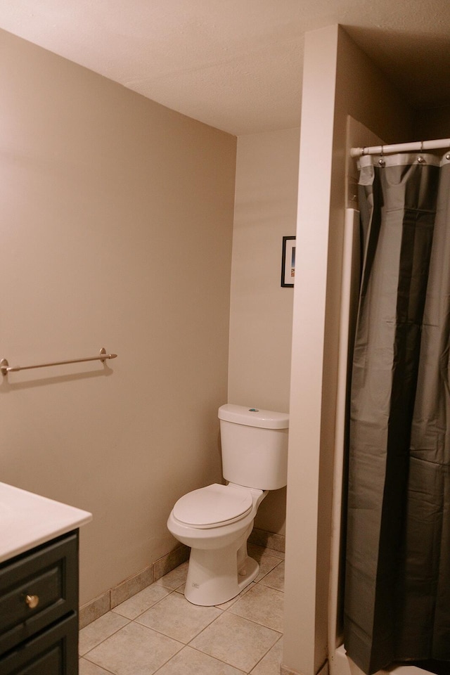 full bathroom featuring vanity, toilet, tile patterned floors, and curtained shower