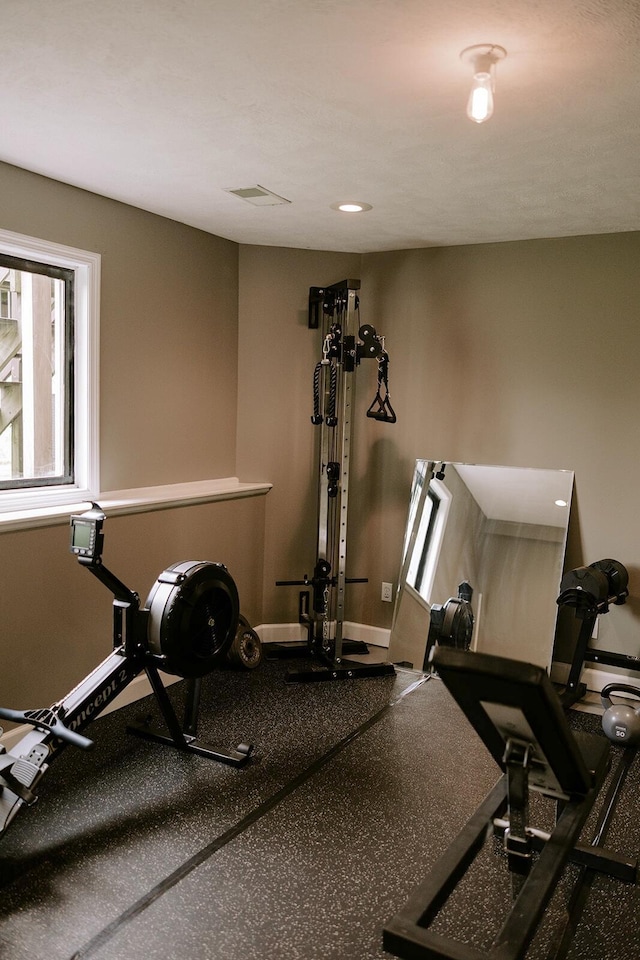 exercise room with baseboards