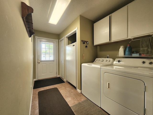 3034 Royalton Heights Rd, Saint Joseph, MI 49085 - laundry room featuring cabinet space, separate washer and dryer, and light tile patterned floors
