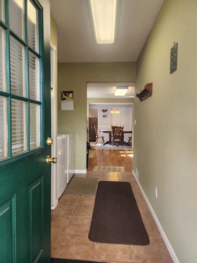 3034 Royalton Heights Rd, Saint Joseph, MI 49085 - corridor featuring independent washer and dryer, tile patterned floors, and baseboards