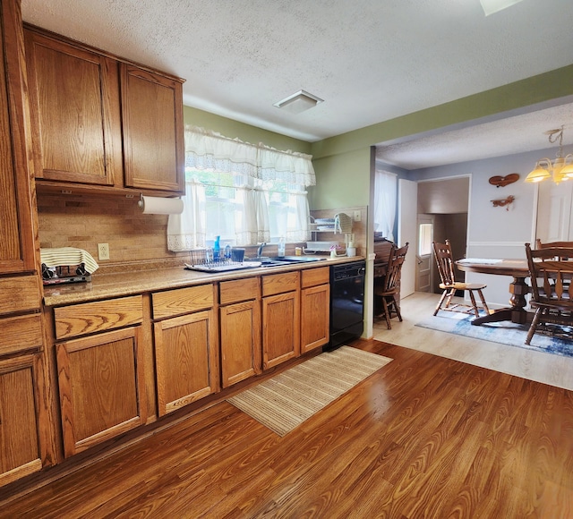 3034 Royalton Heights Rd, Saint Joseph, MI 49085 - kitchen with dishwasher, brown cabinets, a textured ceiling, dark wood-type flooring, and light countertops