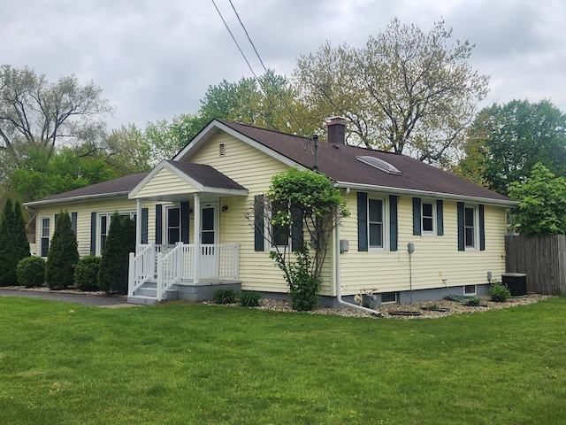 3034 Royalton Heights Rd, Saint Joseph, MI 49085 - view of front of house with a front lawn, a chimney, and central air condition unit