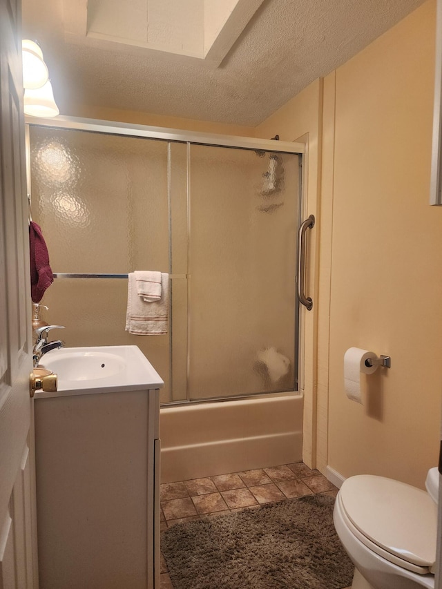 3034 Royalton Heights Rd, Saint Joseph, MI 49085 - bathroom with vanity, bath / shower combo with glass door, toilet, and a textured ceiling