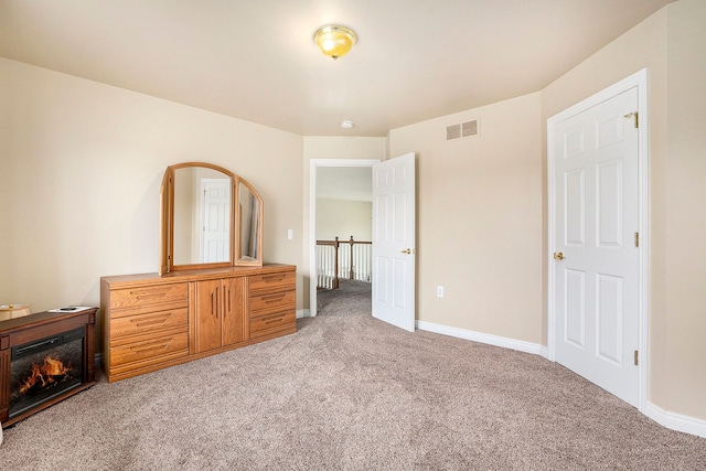 55796 Caesars Dr, Shelby Twp, MI 48315 - unfurnished bedroom featuring light colored carpet, baseboards, and a glass covered fireplace