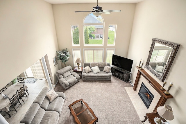 55796 Caesars Dr, Shelby Twp, MI 48315 - living room with a towering ceiling, healthy amount of natural light, a tile fireplace, and a ceiling fan