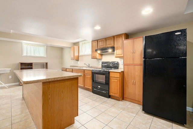 55796 Caesars Dr, Shelby Twp, MI 48315 - kitchen with black appliances, under cabinet range hood, a sink, light countertops, and light tile patterned floors