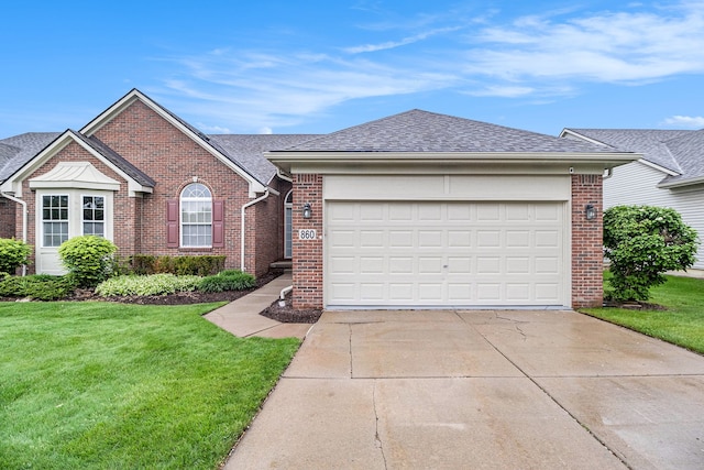 860 Woodhaven Dr, Commerce Twp, MI 48390 - single story home with brick siding, a front lawn, driveway, and a shingled roof