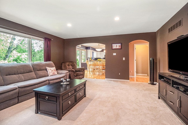 454 Breconshire Dr, Saline, MI 48176 - living area with arched walkways, plenty of natural light, light carpet, and recessed lighting