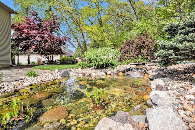 454 Breconshire Dr, Saline, MI 48176 - view of yard with a garden pond