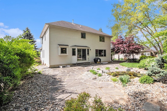 454 Breconshire Dr, Saline, MI 48176 - rear view of house featuring entry steps and a patio area