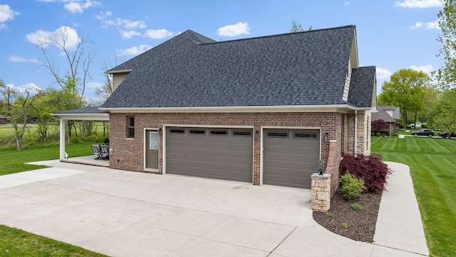 view of property exterior with concrete driveway, a shingled roof, a lawn, and brick siding