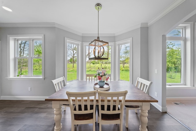 dining area featuring plenty of natural light, baseboards, and crown molding