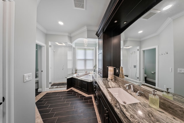 full bath with toilet, a stall shower, ornamental molding, a garden tub, and vanity