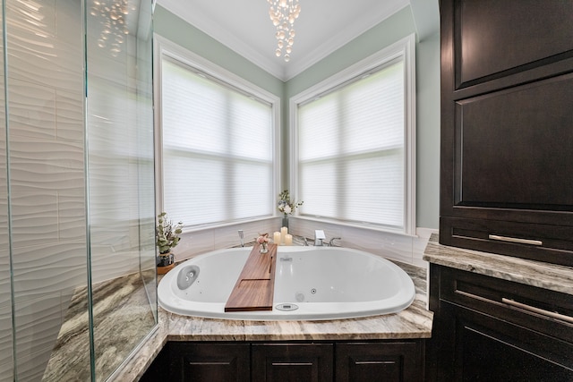 bathroom featuring a whirlpool tub, a chandelier, and crown molding
