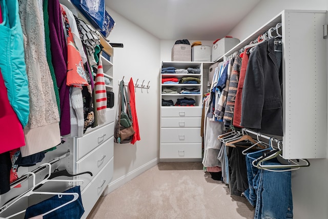 walk in closet with carpet floors