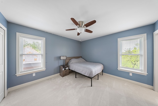 bedroom with carpet floors, baseboards, and a ceiling fan