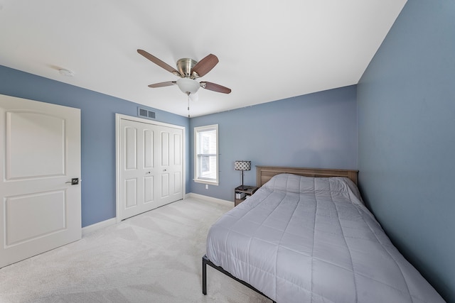 carpeted bedroom featuring baseboards, a closet, and a ceiling fan