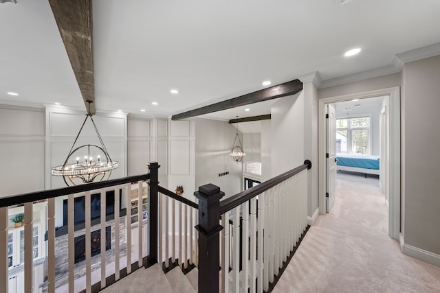 corridor featuring a chandelier, recessed lighting, an upstairs landing, crown molding, and light colored carpet