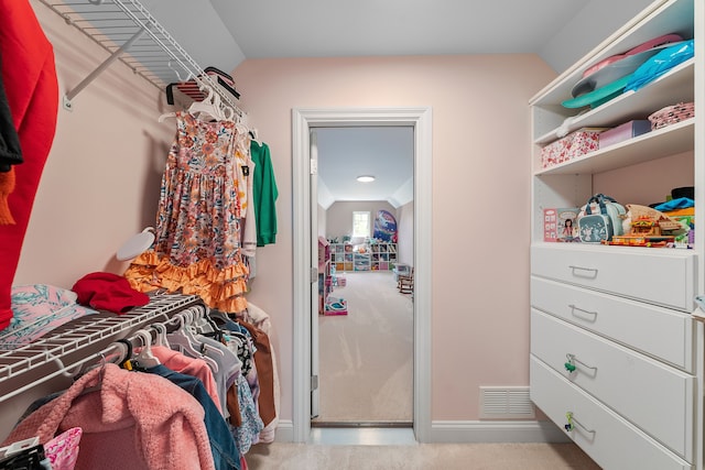 walk in closet with vaulted ceiling