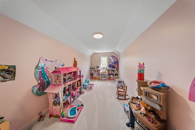 rec room featuring carpet flooring, vaulted ceiling, and baseboards