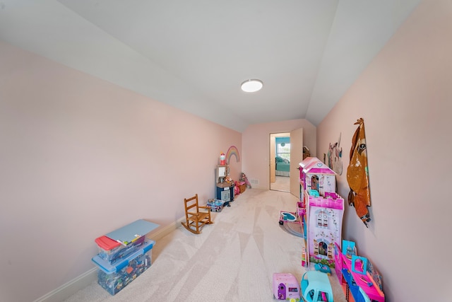 rec room featuring carpet, baseboards, and lofted ceiling