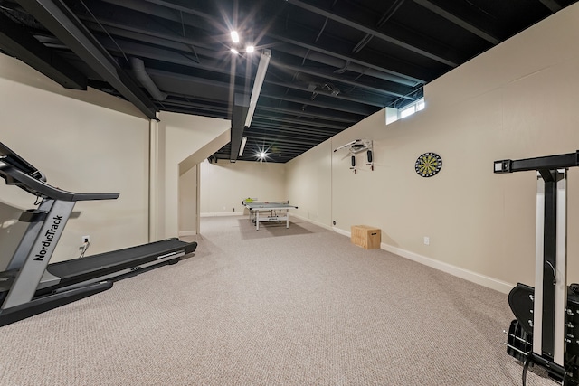 exercise room featuring carpet and baseboards