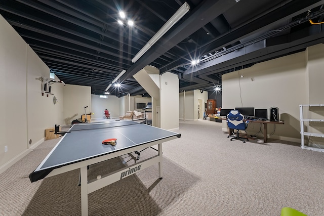 game room with carpet floors, baseboards, and a desk