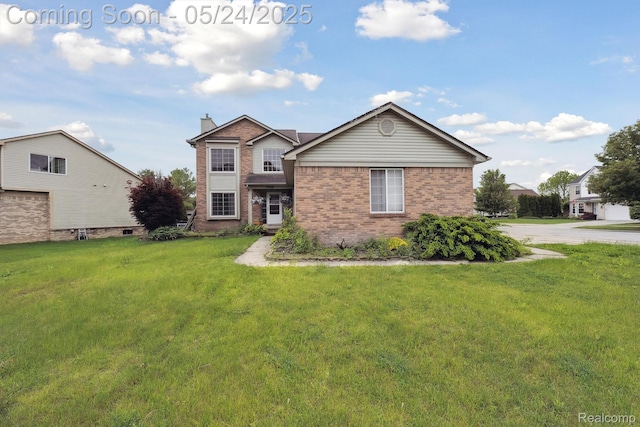 7366 Meadow Ln, Ypsilanti, MI 48197 - traditional home featuring brick siding, a front lawn, and a chimney
