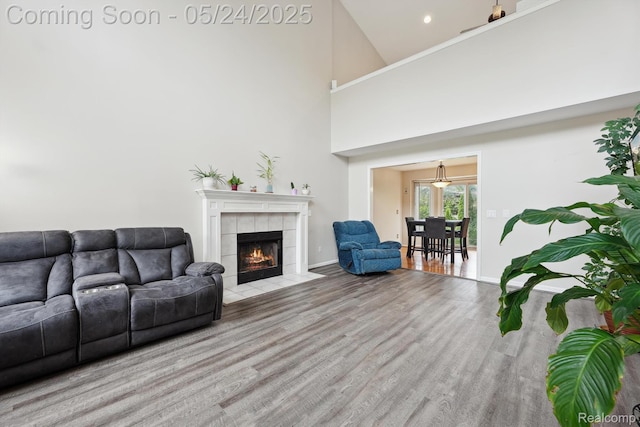 7366 Meadow Ln, Ypsilanti, MI 48197 - living room with a fireplace, wood finished floors, baseboards, a high ceiling, and recessed lighting