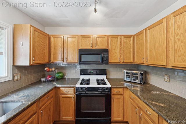 7366 Meadow Ln, Ypsilanti, MI 48197 - kitchen featuring black microwave, range with gas stovetop, backsplash, dark stone countertops, and a sink