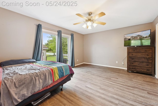 7366 Meadow Ln, Ypsilanti, MI 48197 - bedroom featuring baseboards, wood finished floors, access to exterior, and ceiling fan
