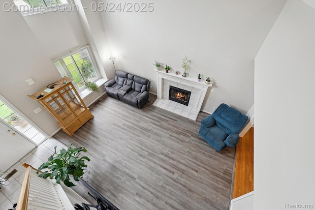 7366 Meadow Ln, Ypsilanti, MI 48197 - living area with a high ceiling, a fireplace, wood finished floors, and baseboards