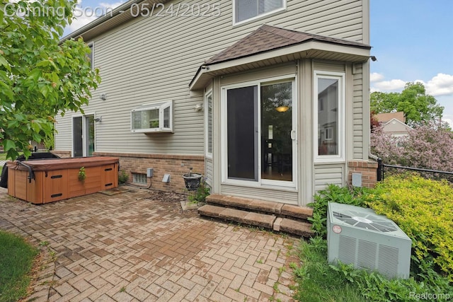 7366 Meadow Ln, Ypsilanti, MI 48197 - back of house featuring a hot tub, a patio, brick siding, central air condition unit, and a shingled roof