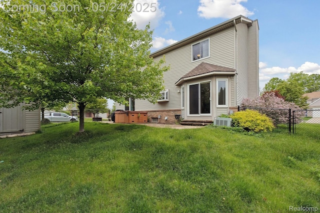 7366 Meadow Ln, Ypsilanti, MI 48197 - back of property featuring a hot tub and central air condition unit