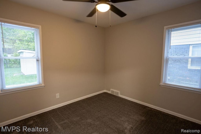 20484 Roscommon St, Harper Woods, MI 48225 - empty room featuring plenty of natural light, dark colored carpet, and baseboards