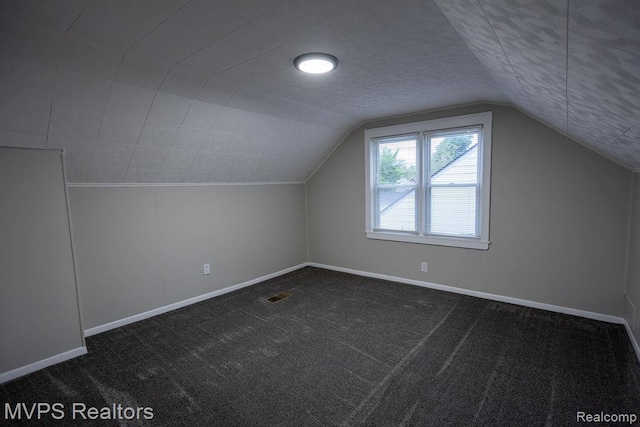 20484 Roscommon St, Harper Woods, MI 48225 - bonus room featuring baseboards, vaulted ceiling, and dark colored carpet