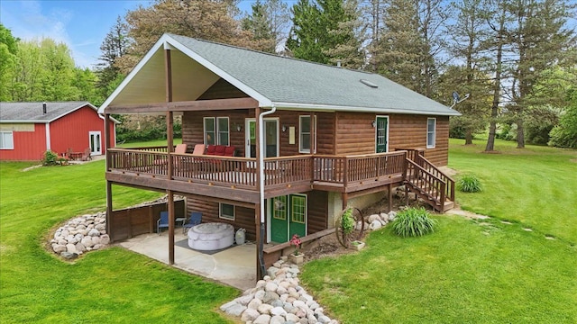 rear view of house featuring a patio, faux log siding, a wooden deck, and a lawn