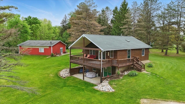 rear view of property with a wooden deck, a yard, and a patio area