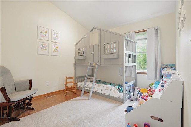 bedroom featuring wood finished floors and baseboards